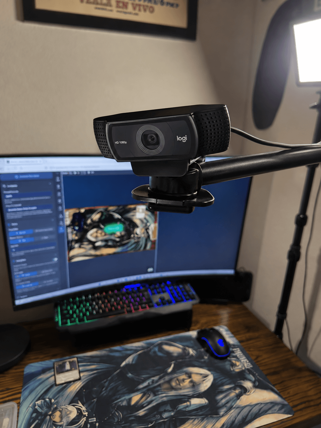 Close-up of a Logitech 1080p webcam clamped to the overhead boom arm